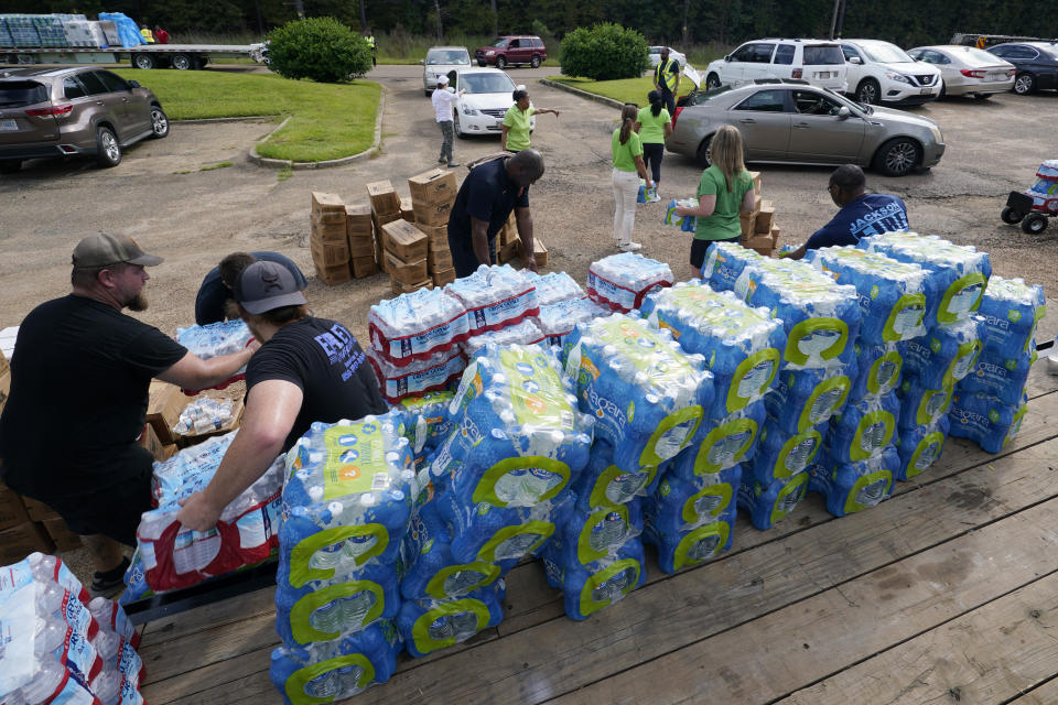 Jackson City firefighters and Humana volunteers help distribute over forty thousand bottles of water and three thousand MRE's to Jackson residents Friday Sep. 2, 2022, in Jackson, Miss. (AP Photo/Steve Helber)