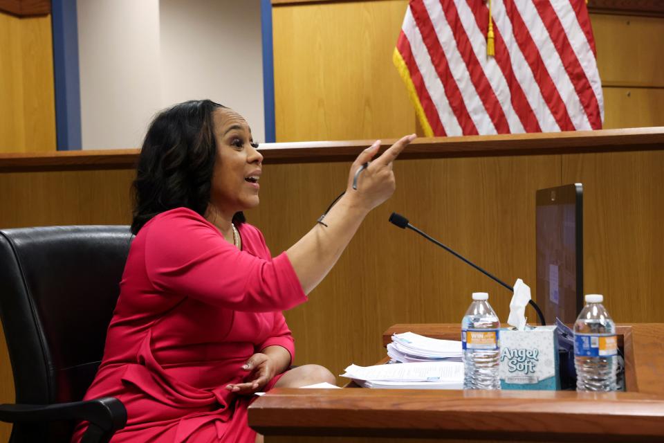 Attorney Fani Willis speaks from a witness stand during a hearing in the case of State of Georgia v. Donald John Trump at the Fulton County Courthouse in Atlanta on Thursday.