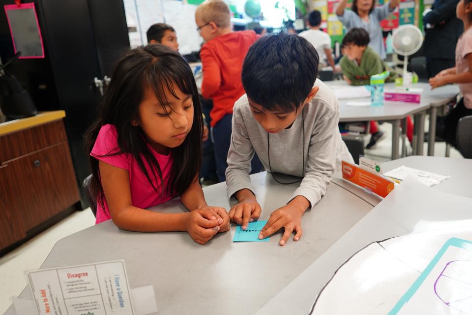 Two elementary school students collaborate on a project in School District U-46, west of Chicago. The district has tried to make classes more hands-on, using a model expected to reduce behavior problems in addition to improving academic outcomes.