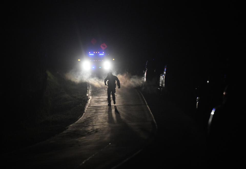 Oct 26, 2023; Bowdoin, Maine, USA Law enforcement officers search the area of Bowdoin, Maine the day after a suspect killed at least 18 people during multiple shootings in the Lewiston area. Mandatory Credit: Camille Fine-USA TODAY