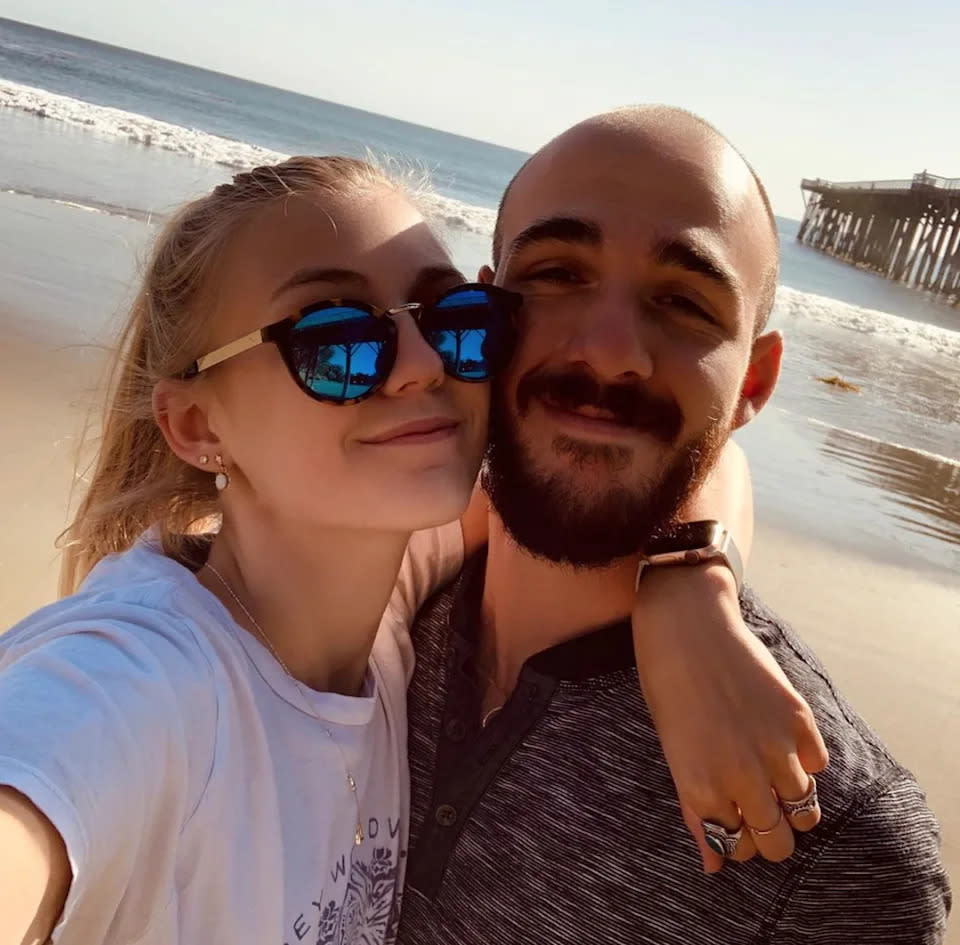 Gabby Petito and Brian Laundrie pose for a selfie on a beach