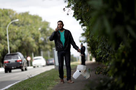 A man carries empty gasoline gallons in Brasilia, Brazil May 25, 2018. REUTERS/Ueslei Marcelino