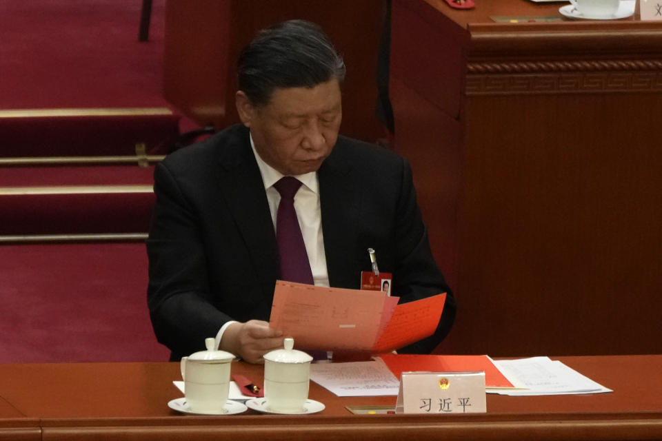 Chinese President Xi Jinping looks at documents during a session of China's National People's Congress (NPC) at the Great Hall of the People in Beijing, Friday, March 10, 2023. (AP Photo/Mark Schiefelbein)