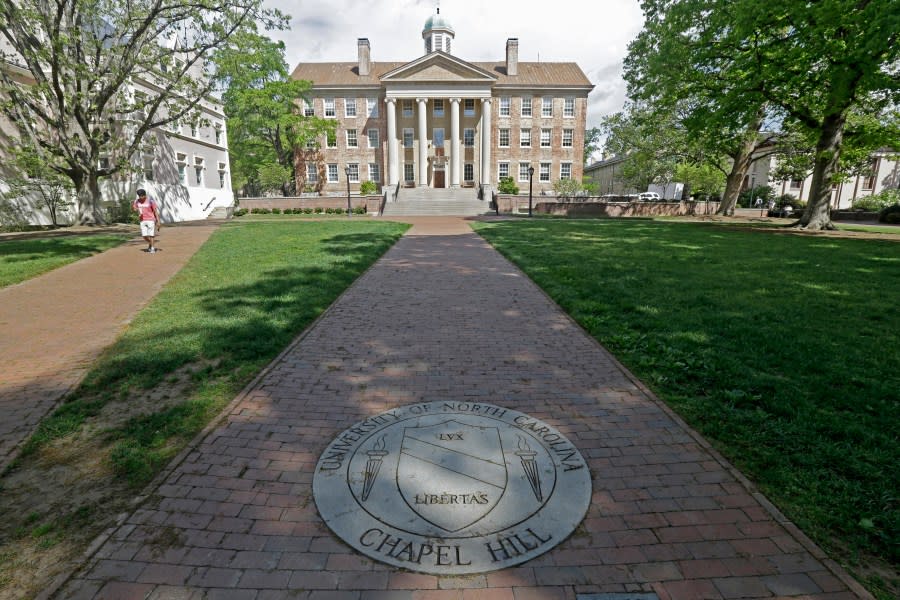 FILE – In this Monday, April 20, 2015, photo, a sidewalk leads to the South Building on campus at The University of North Carolina in Chapel Hill, N.C. The University of North Carolina Board of Governors is expected to vote on repealing and replacing its diversity policy that impacts 17 schools across the state. The board’s agenda says the vote will occur on Thursday, May 23, 2024. (AP Photo/Gerry Broome, File)