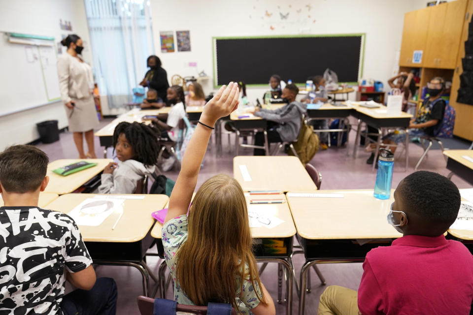 A student raises their hand in a classroom at Tussahaw Elementary school on Wednesday, Aug. 4, 2021, in McDonough, Ga. Schools have begun reopening in the U.S. with most states leaving it up to local schools to decide whether to require masks. (AP Photo/Brynn Anderson)