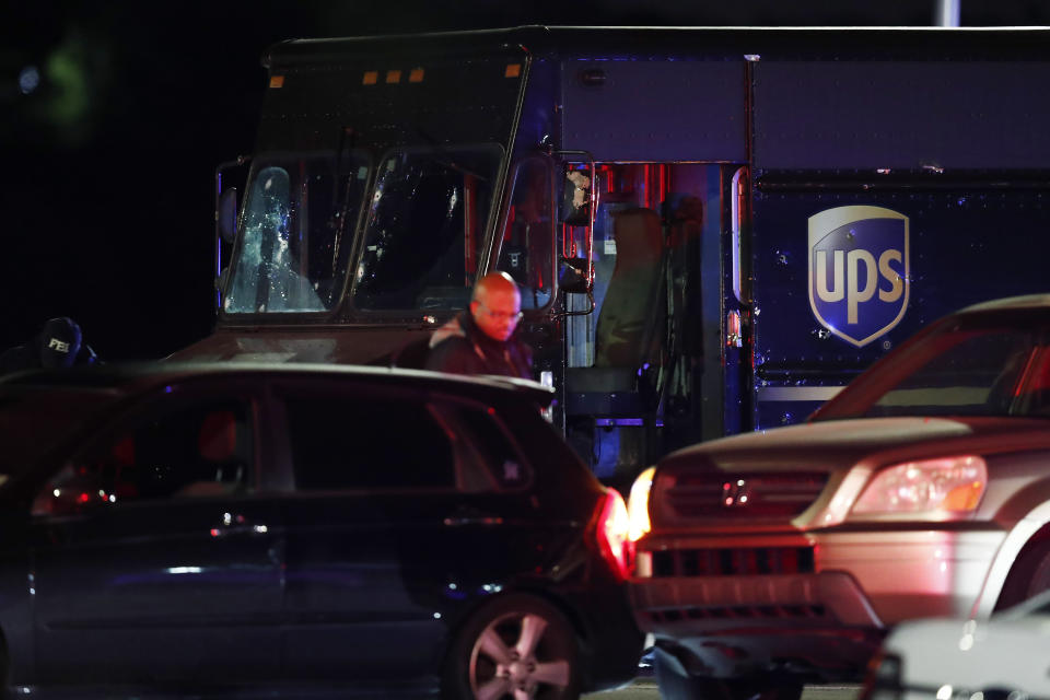 FILE - In this Dec. 5, 2019, file photo, authorities investigate the scene of a shooting in Miramar, Fla., that left four people, including a UPS driver, dead. The family of Frank Ordonez the UPS driver slain during the police shootout, have filed a lawsuit Wednesday, Sept. 16, 2020, against several law enforcement agencies. The say that officers acted negligently when they opened fire on two robbers who were holding him hostage inside his van. (AP Photo/Brynn Anderson, File)