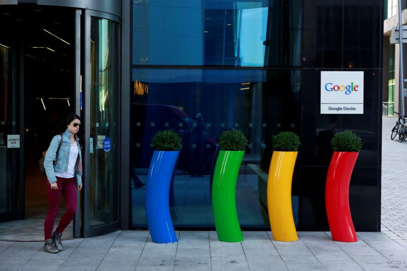 FILE PHOTO: FILE PHOTO: A woman walks past the Google offices near the city centre in Dublin