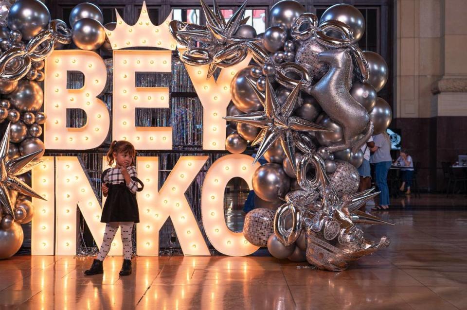 Maria Sanchez stands for a photo in front of a Beyoncé sign at Union Station on Friday.