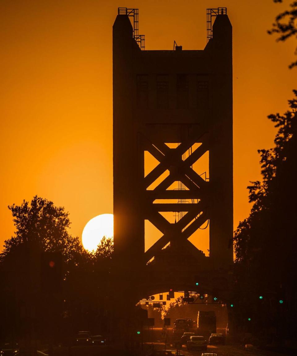 The sun sets near the Tower Bridge in downtown Wednesday, Aug. 15, 2019, as temperatures climb into the triple digits this week in Sacramento.