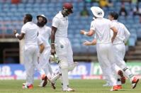 Cricket - West Indies v England - Second Test - National Cricket Ground, Grenada - 25/4/15 England's players celebrate the wicket of Jason Holder after he was run out by James Anderson Action Images via Reuters / Jason O'Brien Livepic EDITORIAL USE ONLY.