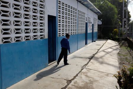 A kid walks past a classroom on the first day of school, in Caucagua, Venezuela September 17, 2018. REUTERS/Marco Bello
