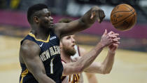 New Orleans Pelicans' Zion Williamson, left, and Cleveland Cavaliers' Dean Wade battle for a rebound in the second half of an NBA basketball game, Sunday, April 11, 2021, in Cleveland. (AP Photo/Tony Dejak)