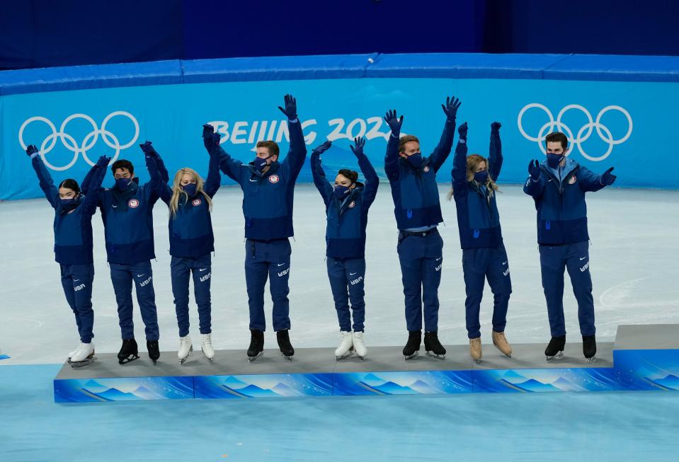 The U.S. team is introduced during the victory ceremony after winning the silver medal for the figure skating team competition at the Beijing Olympics.