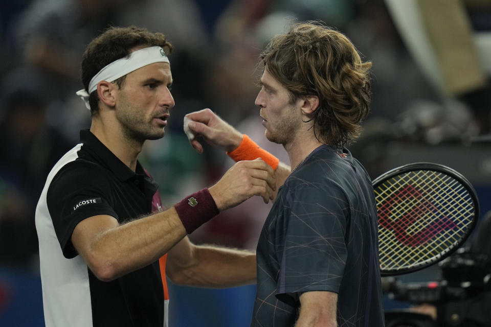 Andrey Rublev of Russia, right, hugs with Grigor Dimitrov of Bulgaria after beating him in the men's singles semifinal match of the Shanghai Masters tennis tournament at Qizhong Forest Sports City Tennis Center in Shanghai, China, Saturday, Oct. 14, 2023. (AP Photo/Andy Wong)