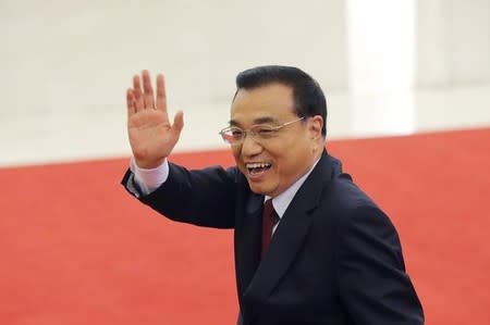 China's Premier Li Keqiang waves as he leaves after a news conference following the closing ceremony of China's National People's Congress (NPC) at the Great Hall of the People in Beijing, China, March 16, 2016. REUTERS/Kim Kyung-hoon -