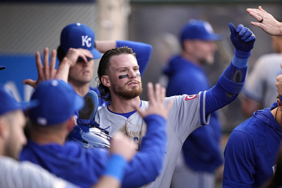 Kansas City Royals' Bobby Witt Jr. is congratulated by teammates in the dugout after scoring on a double by Salvador Perez during the first inning of a baseball game against the Los Angeles Angels Saturday, May 11, 2024, in Anaheim, Calif. (AP Photo/Mark J. Terrill)