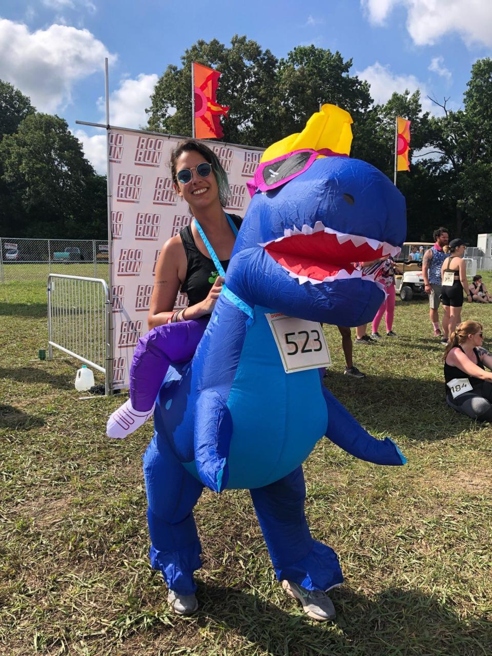 Cristina Garza ran the entire 5K while riding an inflatable dinosaur.