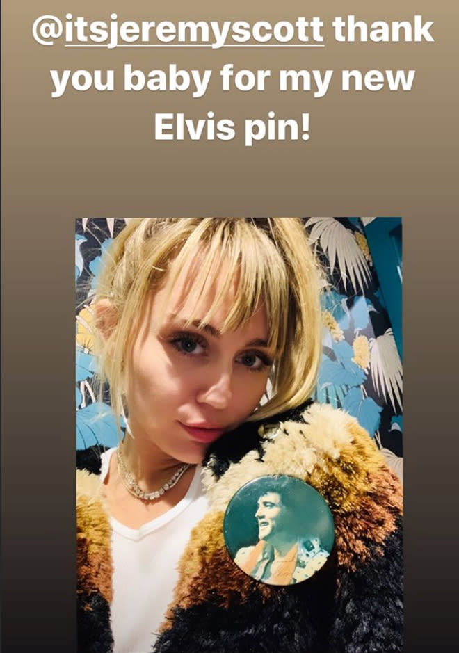 A photo of Miley Cyrus wearing a faux fur jacket and an Elvis Presley pin.