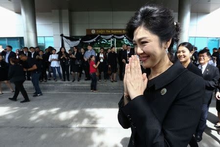 Ousted former Thai prime minister Yingluck Shinawatra gestures in a traditional greeting as she leaves the Supreme Court in Bangkok, Thailand, July 21, 2017. REUTERS/Athit Perawongmetha