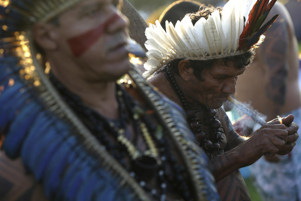 A Gaviao indigenous man smokes his traditional pipe during an annual three-day campout protest known as the Free Land Encampment, in Brasilia, Brazil, Wednesday, April 24, 2019. The event begins amid animosity between Brazil’s indigenous groups and the new government of far-right President Jair Bolsonaro. (AP Photo/Eraldo Peres)