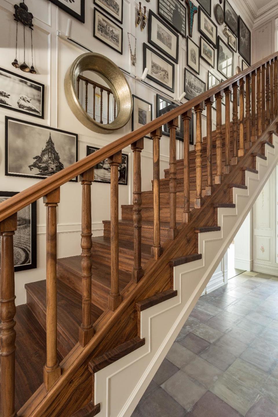 The staircase connecting the social and private zones is made of reclaimed teak. The wall here is peppered with locally sourced images of Manali and artefacts from Ranaut's travels.