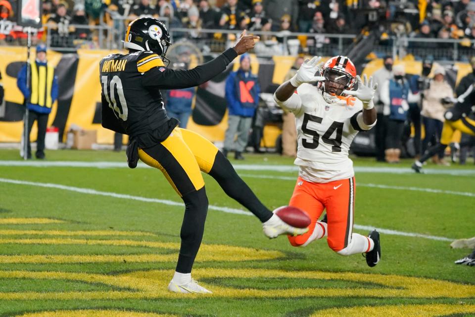 Pittsburgh Steelers punter Corliss Waitman (10) gets a punt away in the end zone as Cleveland Browns linebacker Willie Harvey (54) pressures him during the second half an NFL football game, Monday, Jan. 3, 2022, in Pittsburgh. (AP Photo/Gene J. Puskar)