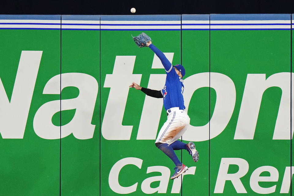 Toronto Blue Jays center fielder George Springer makes a catch at the wall on a ball hit by Tampa Bay Rays' Ji-Man Choi during the fourth inning of a baseball game Wednesday, Sept. 14, 2022, in Toronto. (Frank Gunn/The Canadian Press via AP)