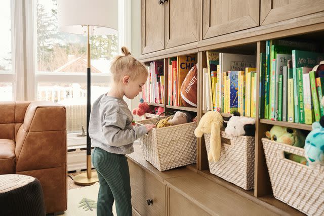 <p>courtesy of Pottery Barn Kids</p> Elliotte Kelce peers into book bin