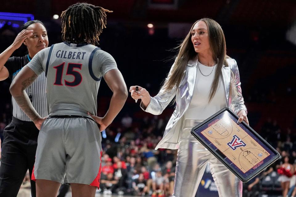 Arizona head coach Adia Barnes talks with Kailyn Gilbert (15) during the second half of an NCAA college basketball game against Colorado on Jan. 5, 2024, in Tucson, Arizona.