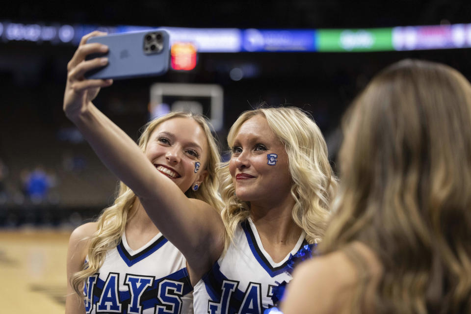 Creighton dance team members Lexi Morris, left, a junior from Minneapolis, and Maddy Janeczko, a senior from Des Moines, take a selfie together before Georgetown plays against Creighton during an NCAA college basketball game Tuesday, Feb. 13, 2024, in Omaha, Neb. (AP Photo/Rebecca S. Gratz)