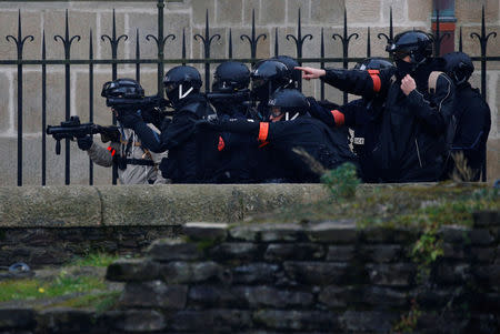 French police officers aim at protesters with their LBD40 rubber bullets during a demonstration of the "yellow vests" movement in Nantes, France January 26, 2019. REUTERS/Stephane Mahe