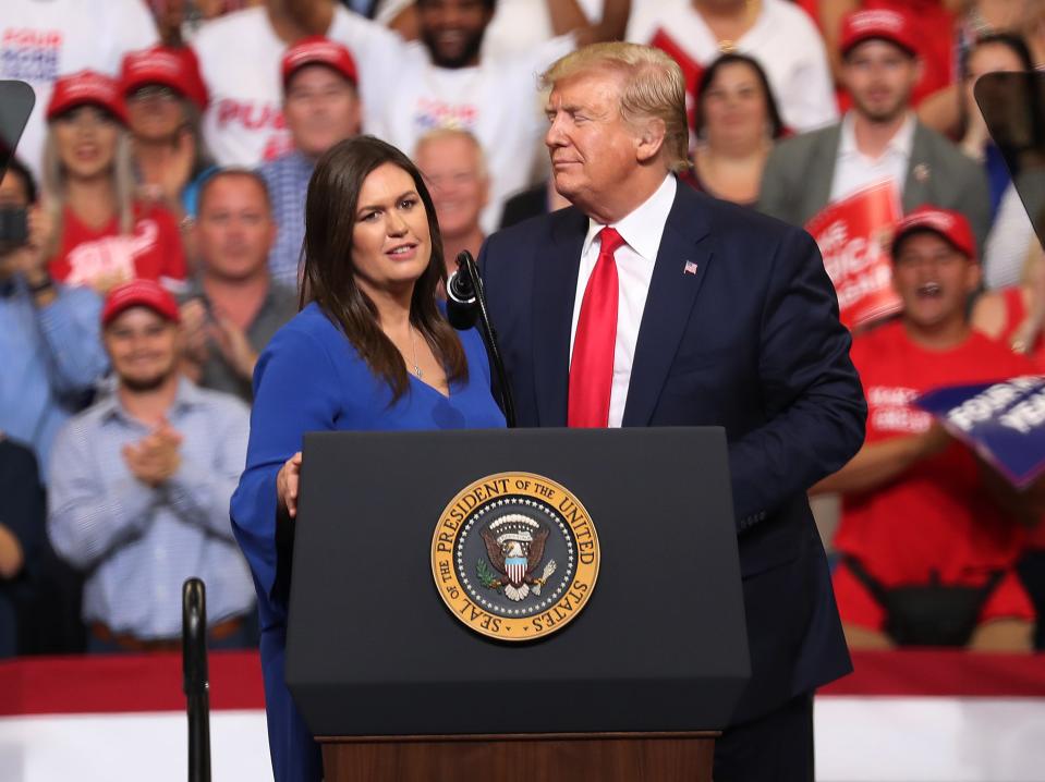 President Donald Trump stands with Sarah Huckabee Sanders, who announced that she is stepping down as the White House press secretary, during his rally where he announced his reelection campaign on June 18, 2019 in Orlando, Florida. (Photo by Joe Raedle/Getty Images)