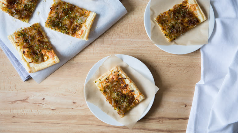 sliced caramelized onion tart on plates