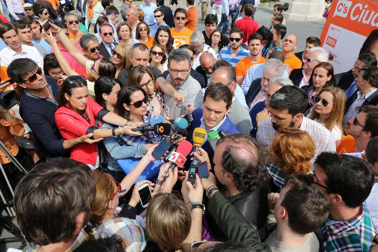 Leader of Spanish political party Ciudadanos (Citizens) Albert Rivera (C) answers to the press during the campaign for local elections in Valladolid on May 14, 2015