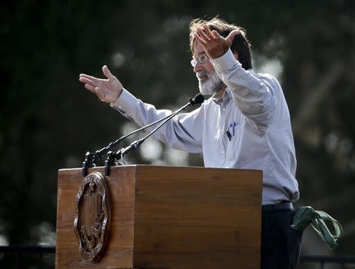 A person speaks into a microphone at a podium