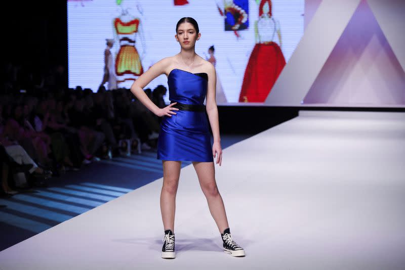 Dresses based on drawings of a victim of Serbia's school shooting are presented during a Fashion Week in Belgrade