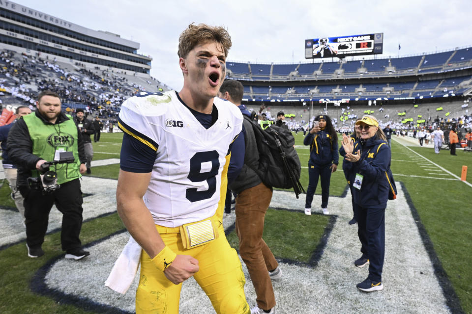Michigan quarterback J.J. McCarthy (9) celebrates a 24-15 win over Penn State in an NCAA college football game, Saturday, Nov. 11, 2023, in State College, Pa. (AP Photo/Barry Reeger)