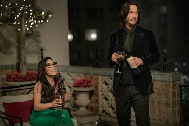 "We had a lot of conversations where we're like, 'We're lost now. Is it the real Keanu or the actor playing Keanu?'" says Evans. Sasha in an Isabel Marant top and Keanu Reeves in "head-to-toe" Tom Ford. Photo: <em>Doane Gregory/Netflix</em>