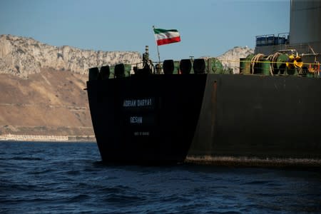 The Iranian flag flies at Iranian oil tanker Adrian Darya 1, before being named as Grace 1, as it sits anchored after the Supreme Court of the British territory lifted its detention order, in the Strait of Gibraltar