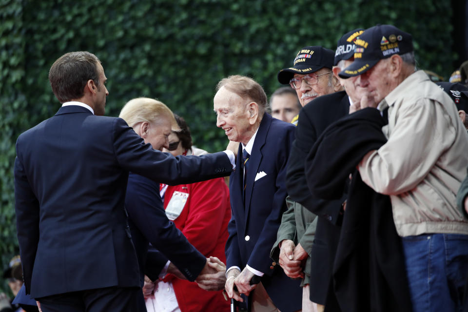 President Donald Trump and French President Emmanuel Macron greet veterans as they arrive to a ceremony to commemorate the 75th anniversary of D-Day at The Normandy American Cemetery, Thursday, June 6, 2019, in Colleville-sur-Mer, Normandy, France. (AP Photo/Alex Brandon)