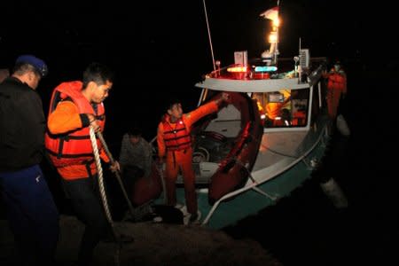 Search and rescue workers are seen on a boat used in the search for passengers from the Sinar Bangun ferry that sank in Lake Toba in Simalungun, North Sumatra, Indonesia June 19, 2018 in this photo taken by Antara Foto.  Antara Foto/Lazuardy Fahmi/ via REUTERS