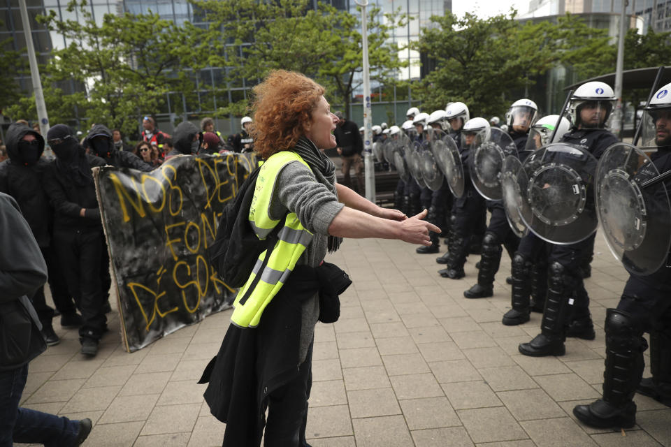 A yellow vest protestor talks to a line of police officers during a demonstration in Brussels, Sunday, May 26, 2019. The demonstration took place as Belgium took to the polls to elect regional, national and European candidates. (AP Photo/Francisco Seco)