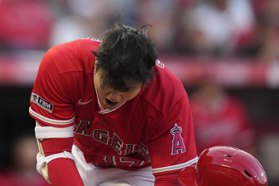 Los Angeles Angels designated hitter Shohei Ohtani (17) lunges to avoid a pitch from Oakland Athletics starting pitcher Ken Waldichuk (64) during the first inning of a baseball game in Anaheim, Calif., Monday, April 24, 2023. (AP Photo/Ashley Landis)