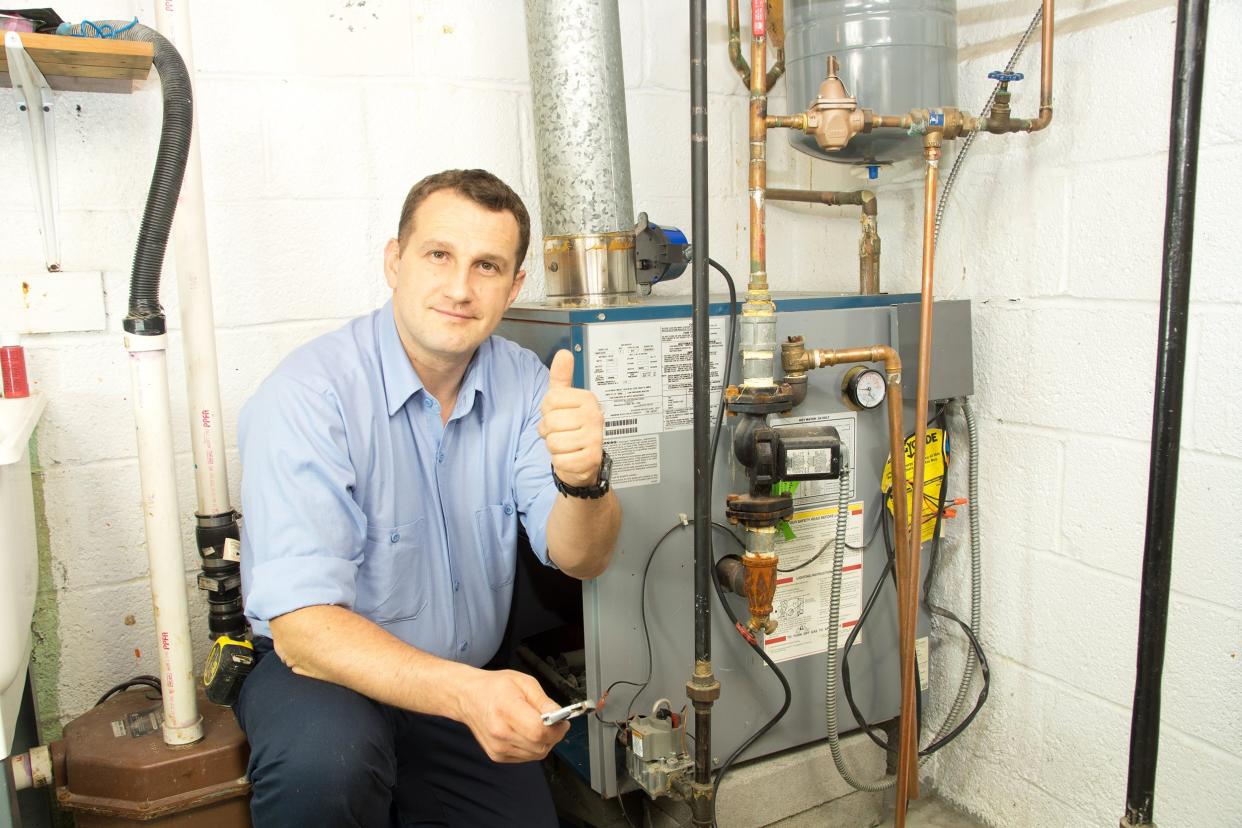 plumber fixing gas furnace