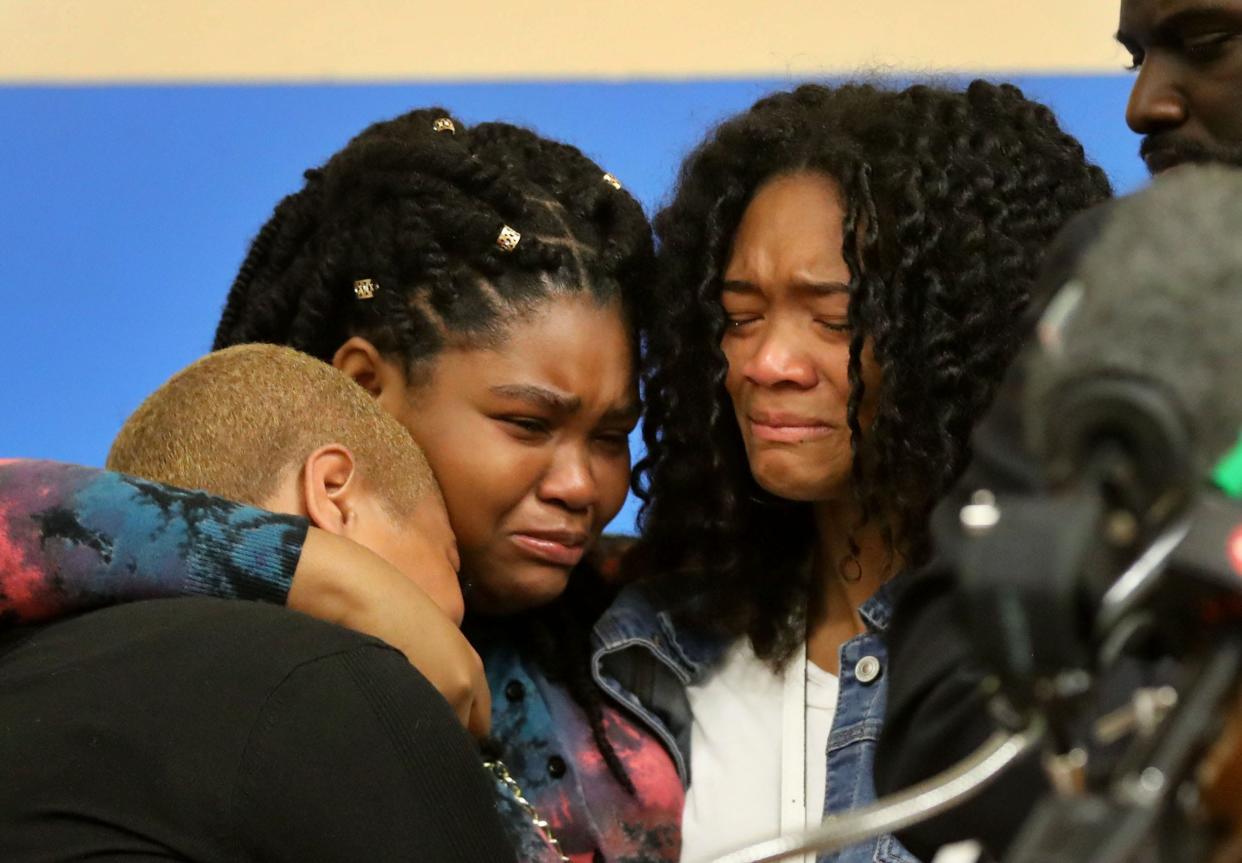 Tiffany Whitfield, left, the daughter of Ruth Whitfield, and Tiffany's daughters Laurell Roberston and Lauren Gibson, become emotional during a press conference in Buffalo, N.Y. May 16, 2022, in which family members, along with civil rights attorney Benjamin Crump spoke about Ruth Whitfield, one of ten people killed in the shooting at a Buffalo supermarket on Saturday. 