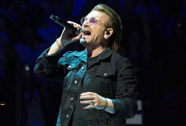 <p>Paul Zimmerman/Getty </p> Bono of U2 performs onstage at Prudential Center in June 2018 in Newark