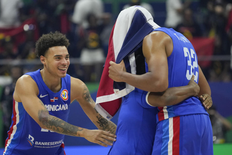 Dominican Republic team celebrates after winning against Angola during their Basketball World Cup group A match at the Araneta Coliseum, Manila, Philippines on Tuesday, Aug. 29, 2023. (AP Photo/Aaron Favila)