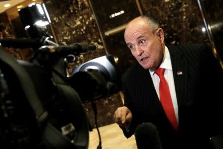 FILE PHOTO: Former New York City Mayor Rudolph Giuliani speaks to members of the media in the lobby at Trump Tower in New York, U.S., January 12, 2017. REUTERS/Mike Segar