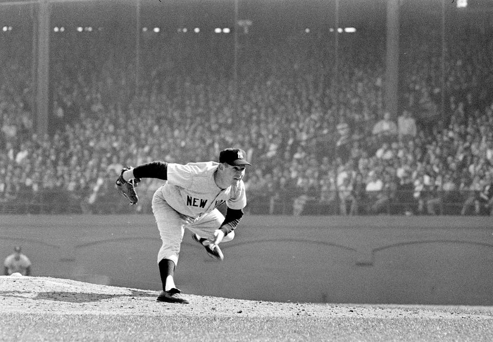 FILE - In this Oct. 12, 1960 file photo, New York Yankees pitcher Whitey Ford throws during the 6th game of the World Series against the Pittsburgh Pirates in Pittsburgh. A family member tells The Associated Press on Friday, Oct. 9, 2020 that Ford died at his Long Island home Thursday night. (AP Photo, File )