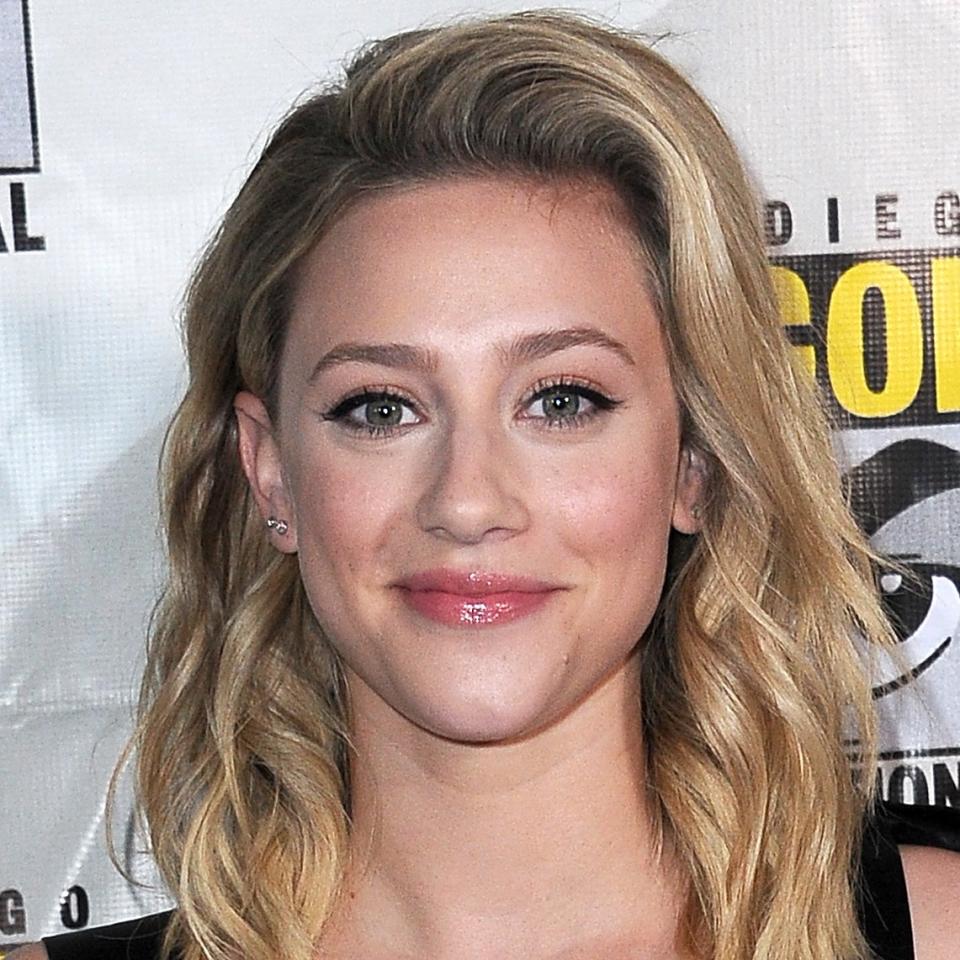 Lili Reinhart, with shoulder-length blonde hair, smiling softly